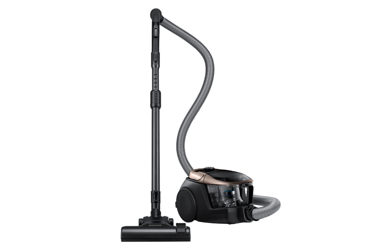 Schwarzer und goldener Staubsauger. Der Staubsauger hat einen langen Griff und Schlauch. Schwarz mit goldenen Akzenten.