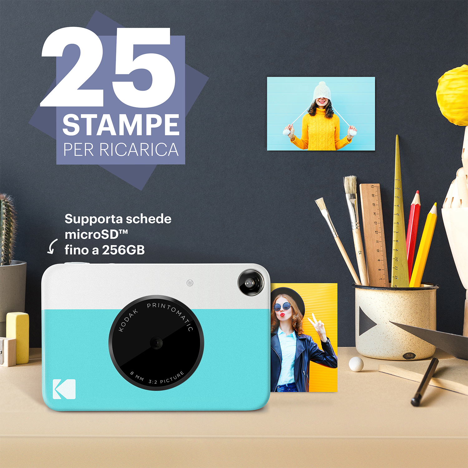 Una fotocamera Kodak turchese e bianca con foto e uno sfondo da scrivania.