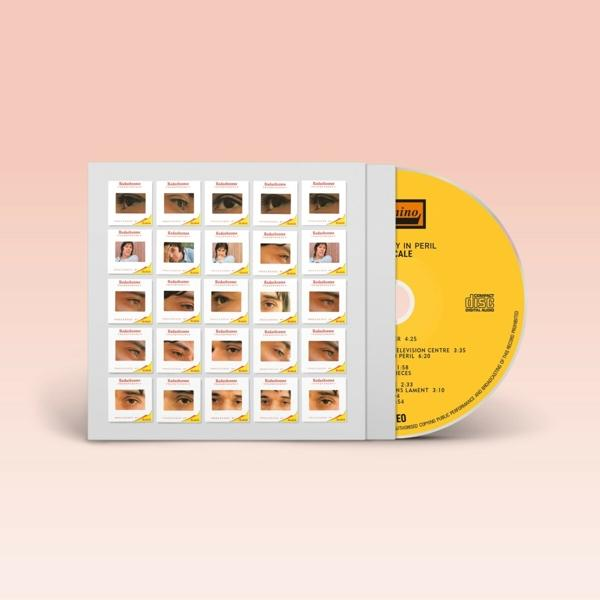 Boîtier de CD avec images d'yeux et un CD jaune. Le CD a du texte, et le boîtier une série d'images.