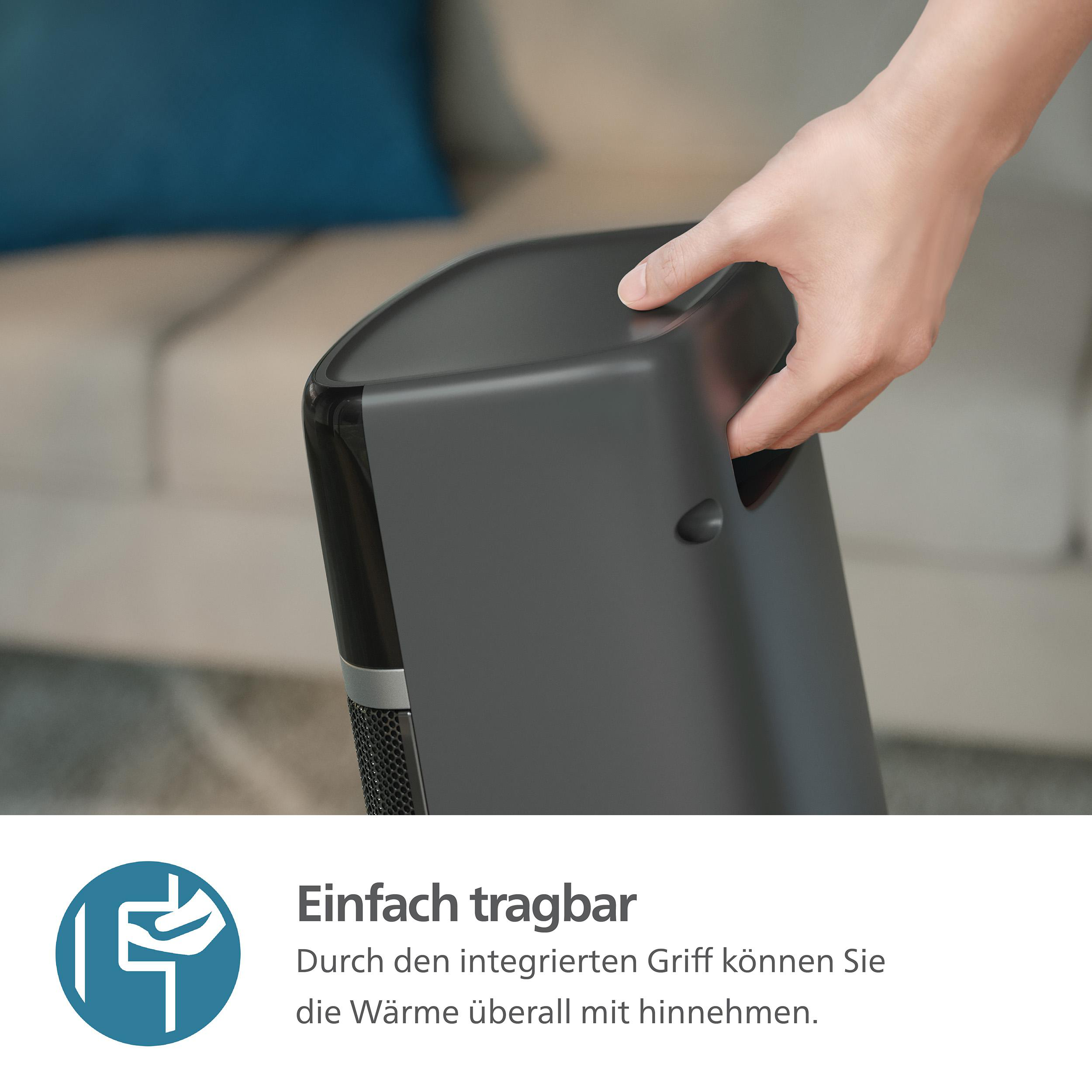 Eine Hand hält ein dunkelgraues tragbares Heizgerät. Raum im Hintergrund. Text auf dem Bild.