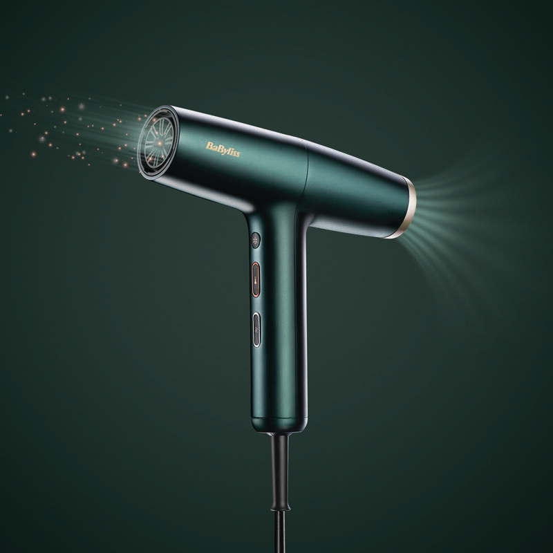 Grüner Haartrockner mit Lichteffekten. Die Marke ist Babyliss.