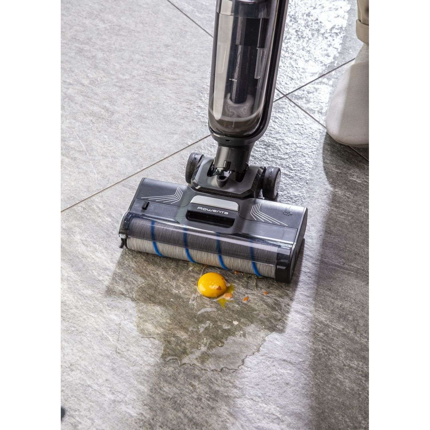 Vacuum cleaner with a spilled egg on the floor.