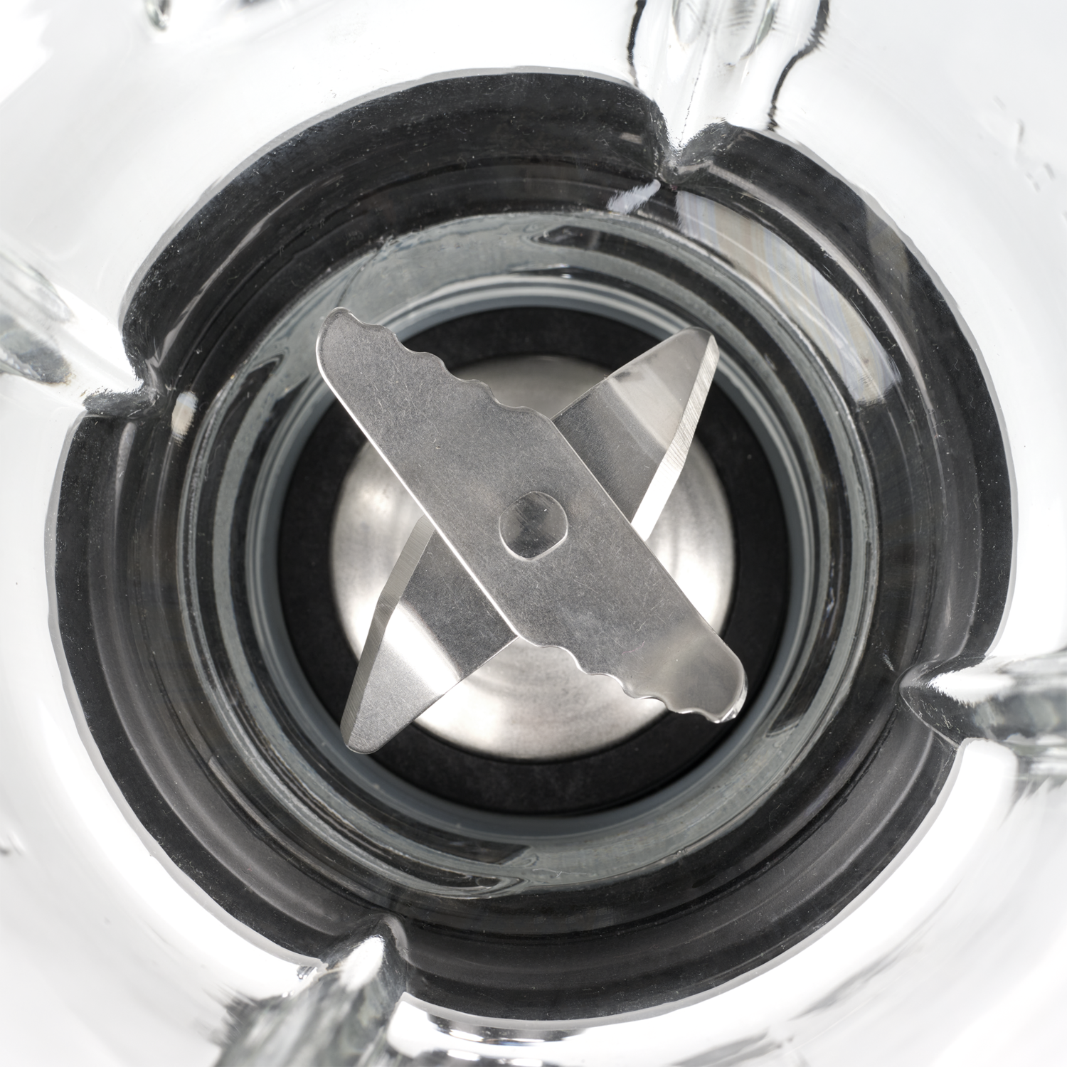 Blender blades inside a glass container, viewed from above.