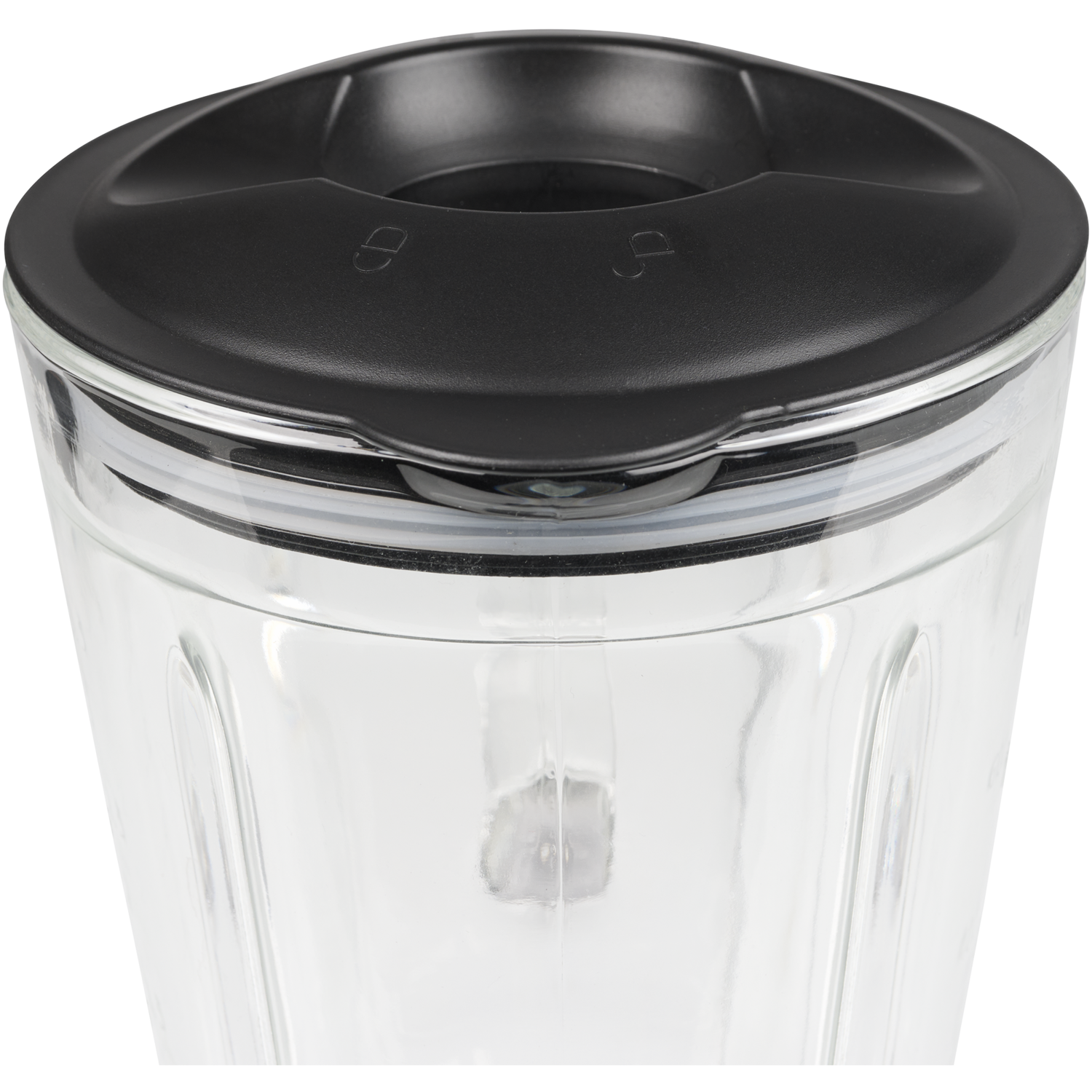 A glass blender jar with a black lid. The lid has two markings on top.
