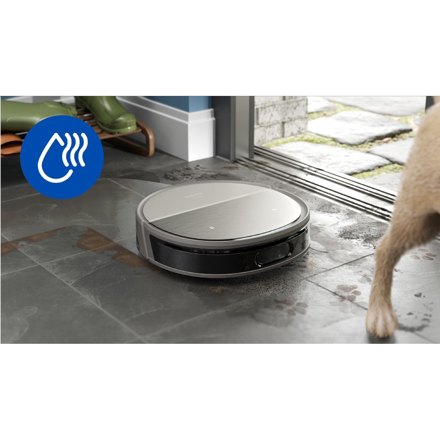 Robot vacuum cleaner on a wet tile floor. Shows water stains and a glimpse of a dog.