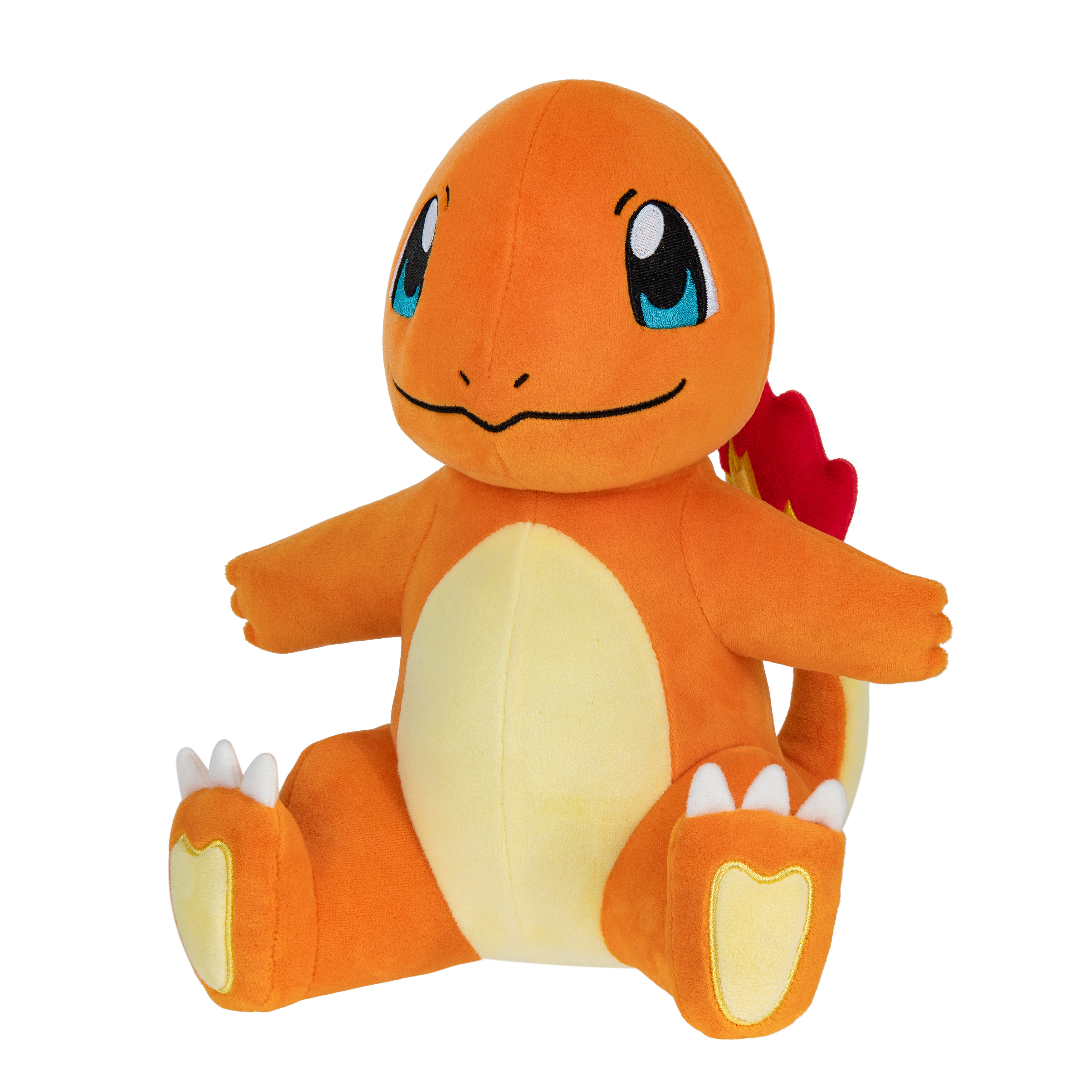 Charmander-Plüschtier mit ausgestreckten Armen. Orange und gelbe Farben, weißer Hintergrund.