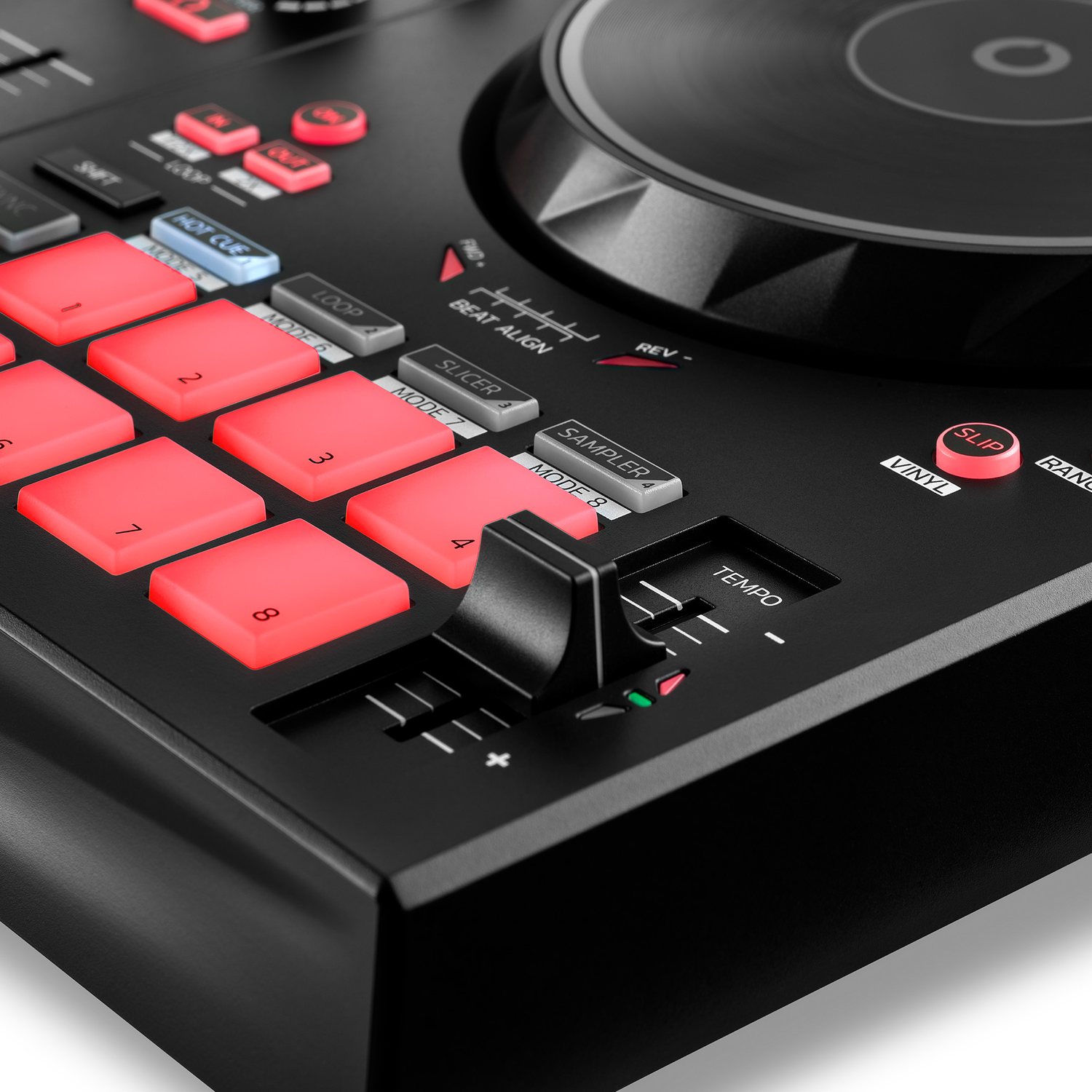 Close-up of a black DJ controller, with red and white buttons and a tempo slider.
