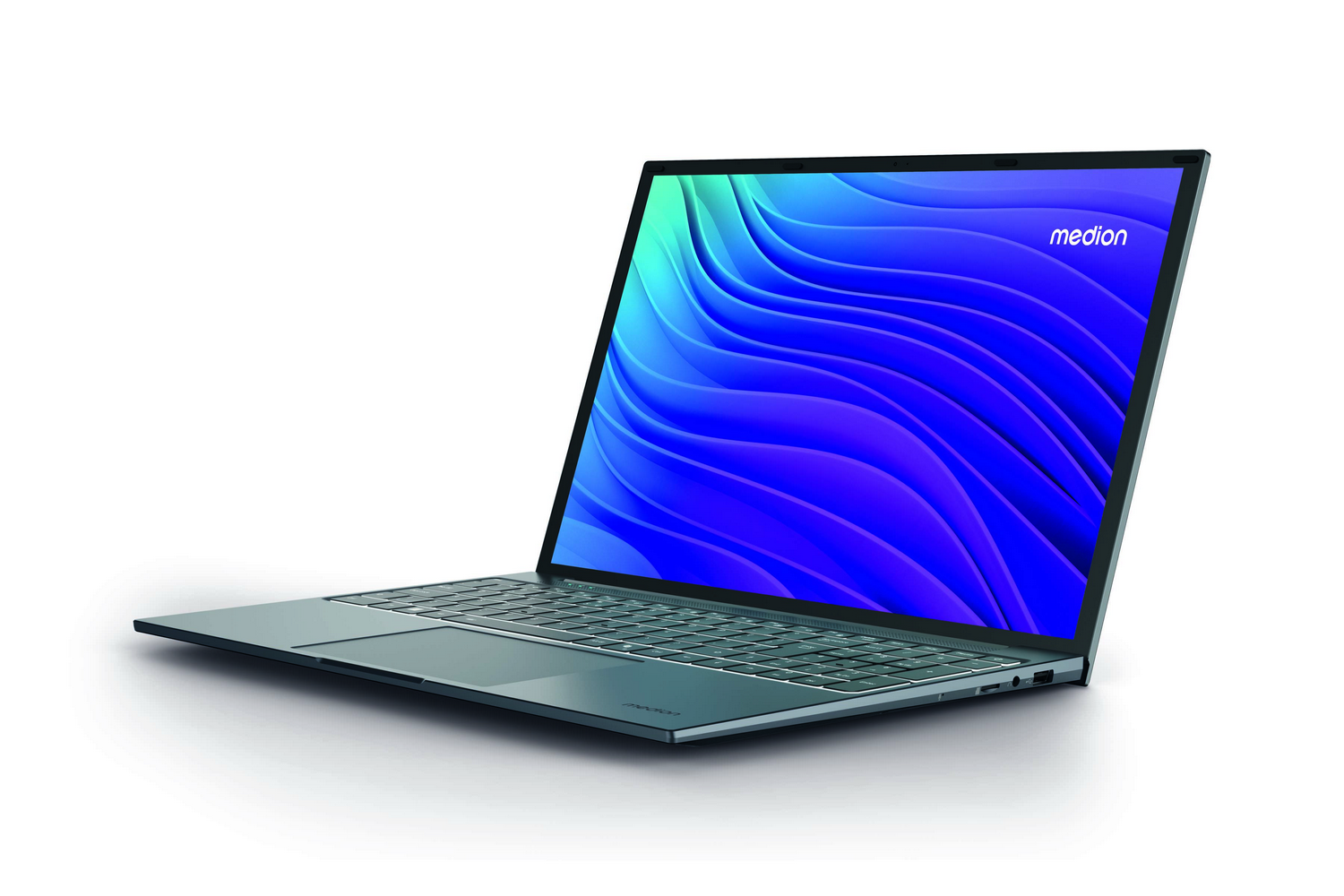 Una computadora portátil turquesa está abierta, mostrando un diseño de ondas azules y moradas. El logotipo de Medion es visible.