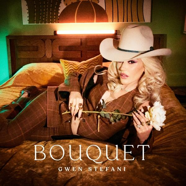 Gwen Stefani auf einem Bett, eine Rose haltend. Text: 'Bouquet'.