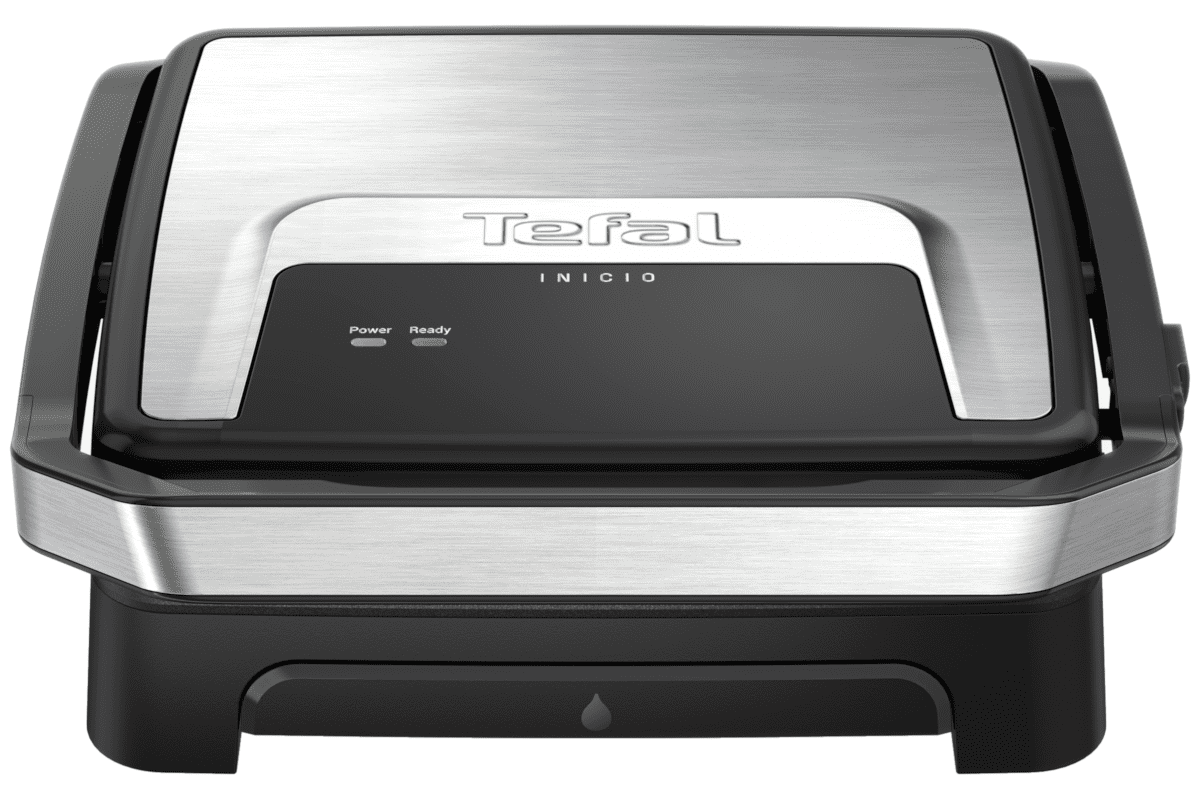 Egy ezüst és fekete Tefal Inicio grill fekete felületen. A vezérlők láthatók.