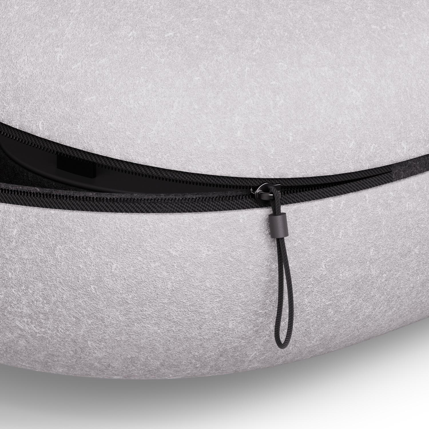 Close-up of a grey, zipped bag. Shows zipper and a black pull tab. Texture visible.