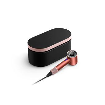 Un secador de pelo oro rosa con una caja de almacenamiento negra.