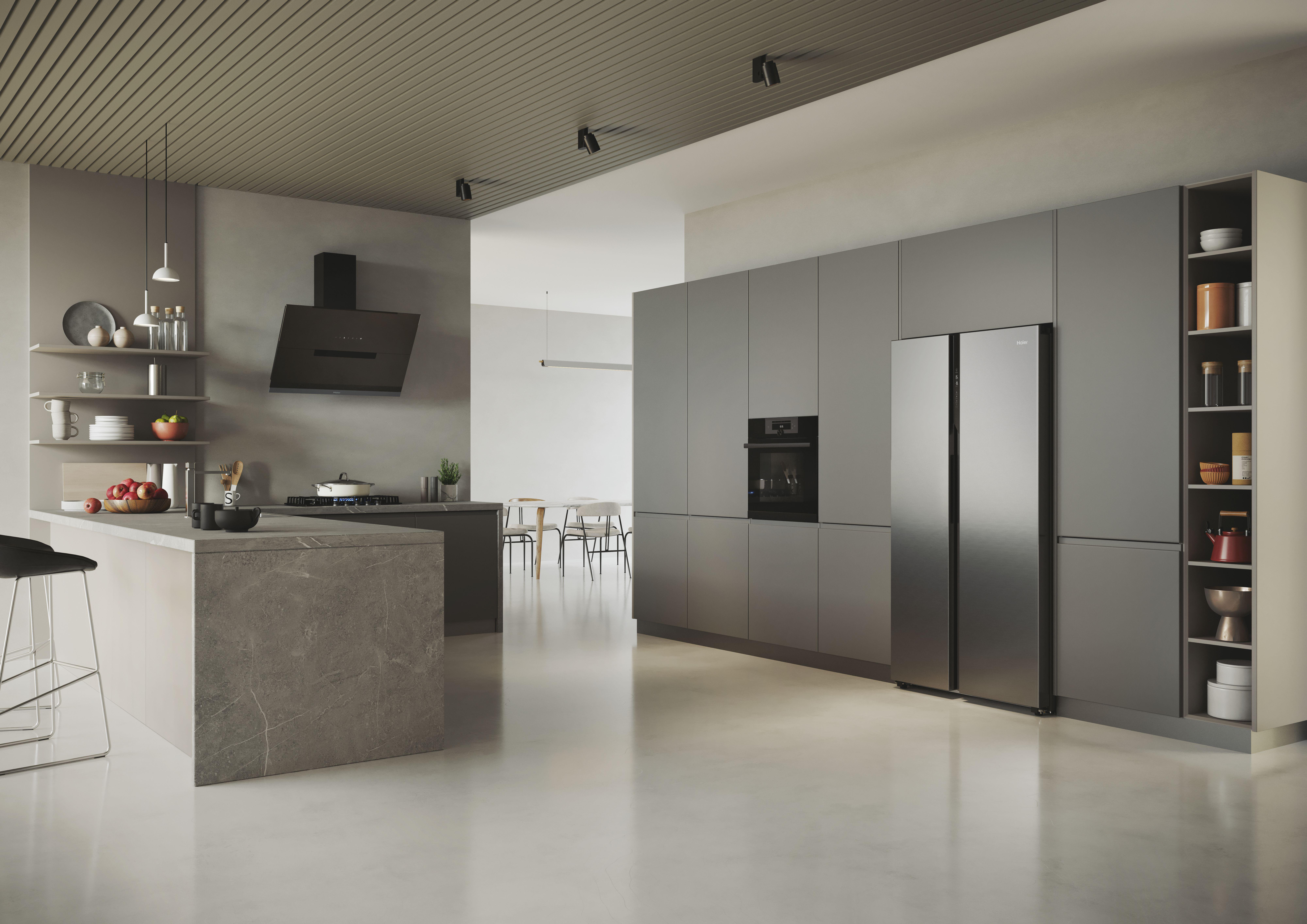 Moderne Küche mit grauen Schränken, Insel und Geräten. Edelstahlkühlschrank sichtbar.