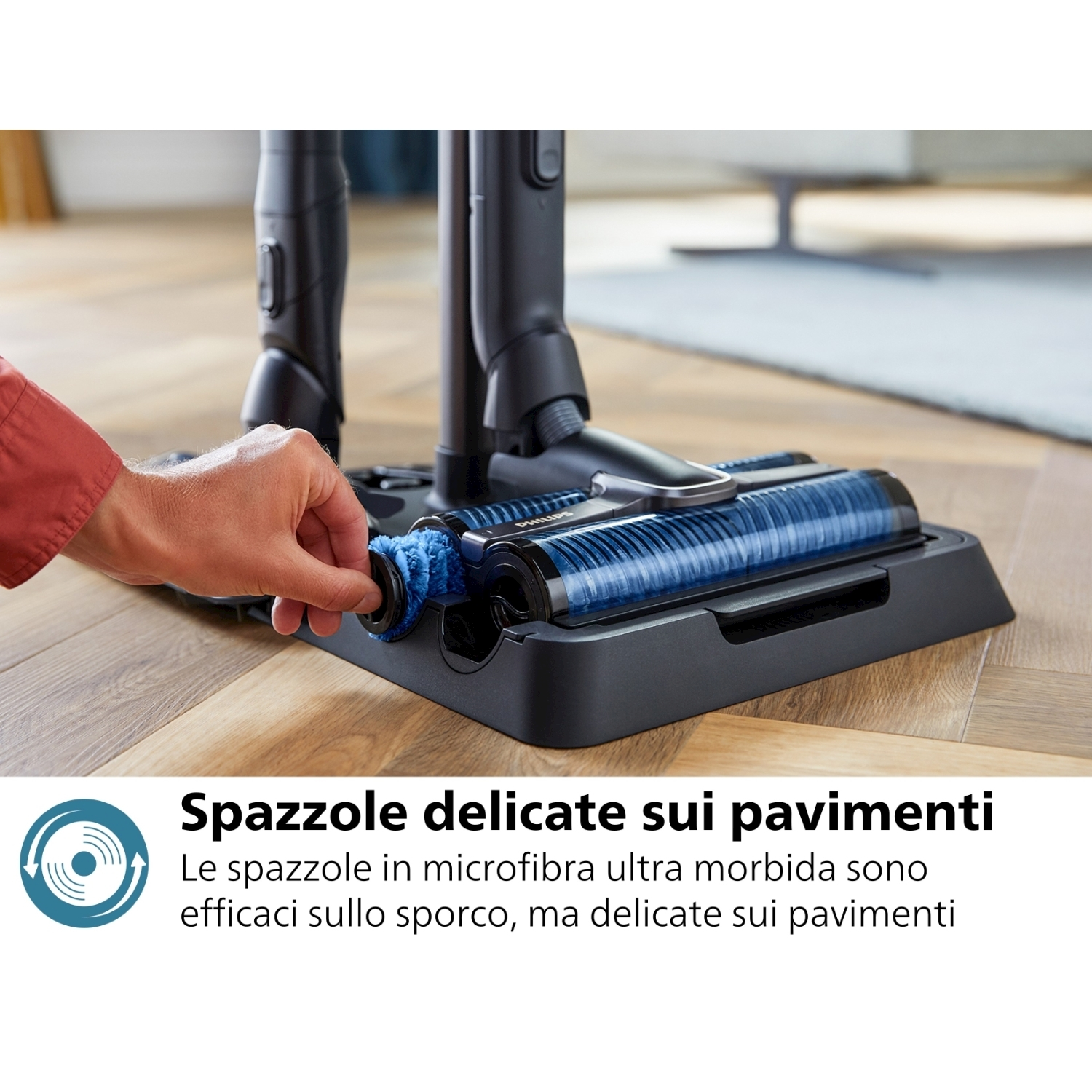 Primo piano di una mano che rimuove una spazzola da un aspirapolvere.