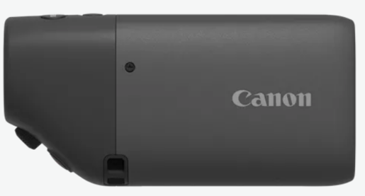 Siyah Canon kamera. Canon logosu görünür. Üstte ve yanda düğmeler.
