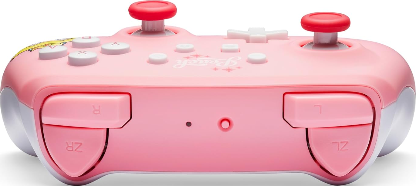 Controller Nintendo Switch rosa con pulsanti rossi e rosa. Sfondo bianco.