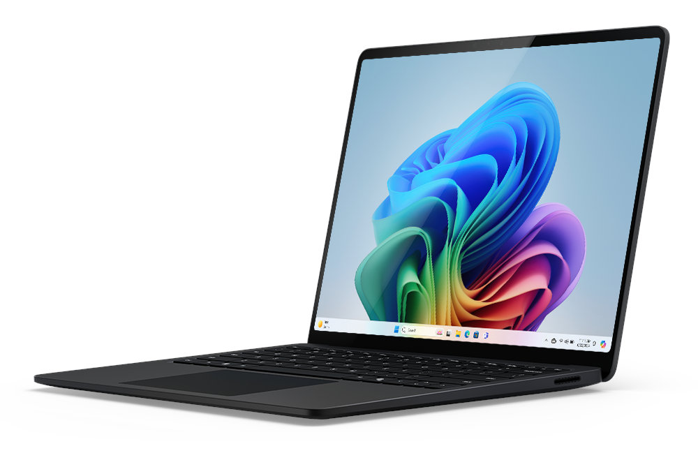 Laptop z kolorowym, abstrakcyjnym tłem na ekranie, ustawiony pod kątem z boku.