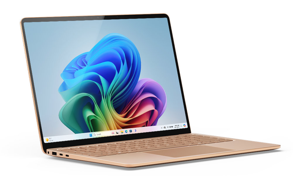 Złoty laptop, otwarty, wyświetlający kolorowe, abstrakcyjne tło pulpitu.