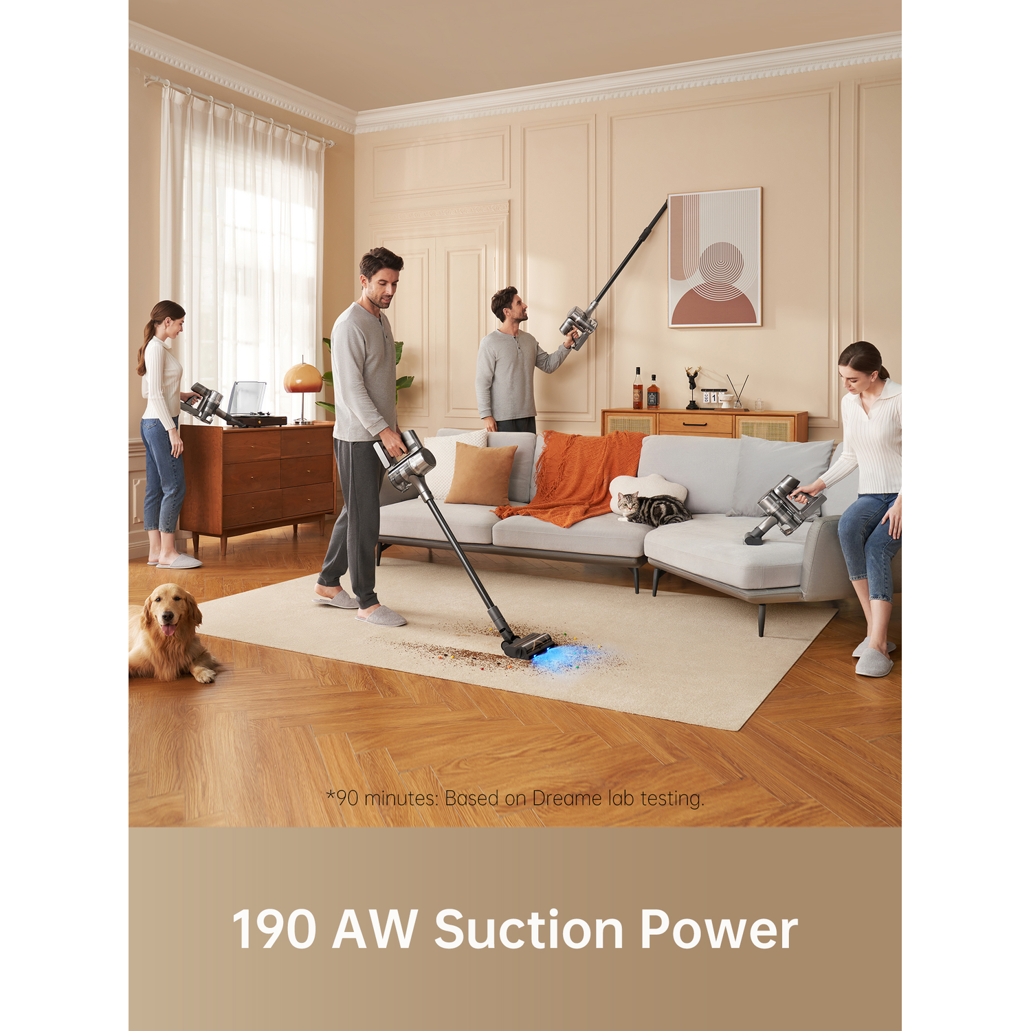 Four people vacuum a living room. One uses a stick vacuum, another cleans a wall. A dog sits on the floor.