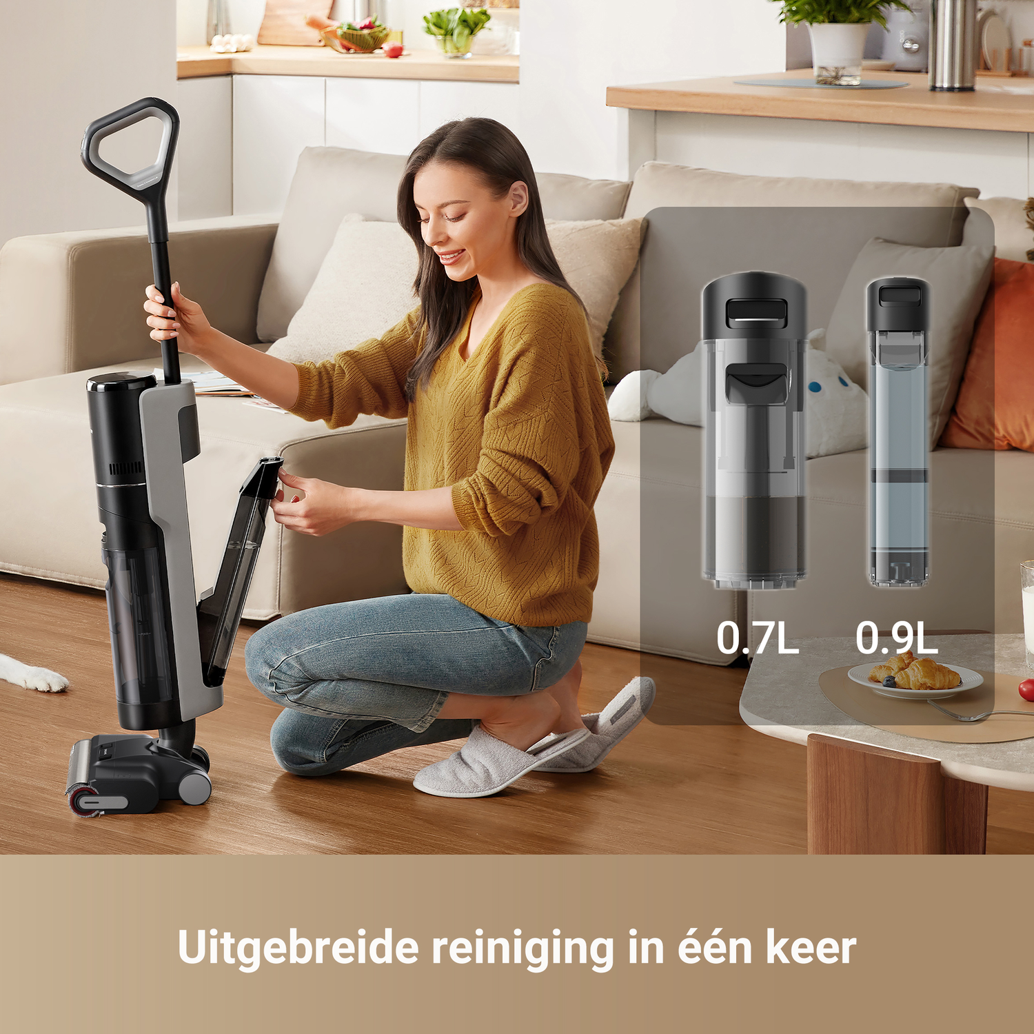 A woman using a vacuum cleaner, with a 0.7L and a 0.9L transparent container on the side.
