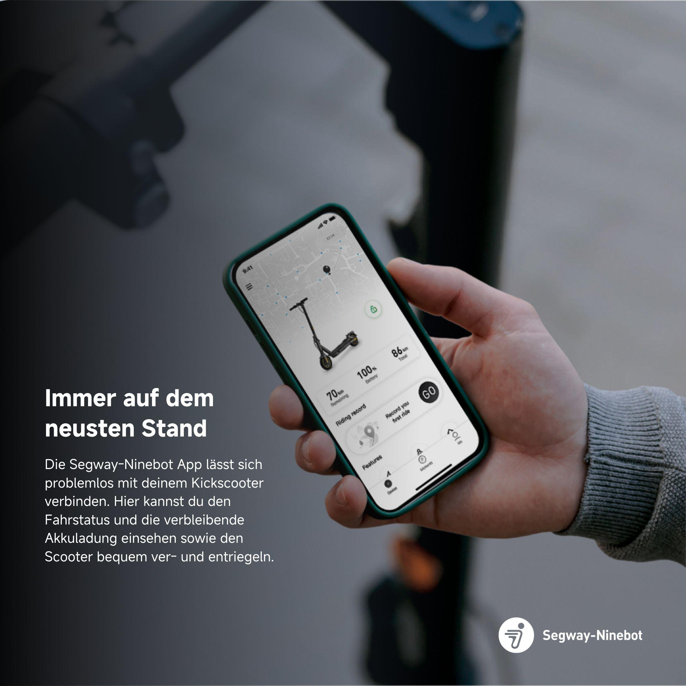 Die Hand einer Person, die ein Smartphone hält. Der Bildschirm zeigt einen Roller und die App-Oberfläche.