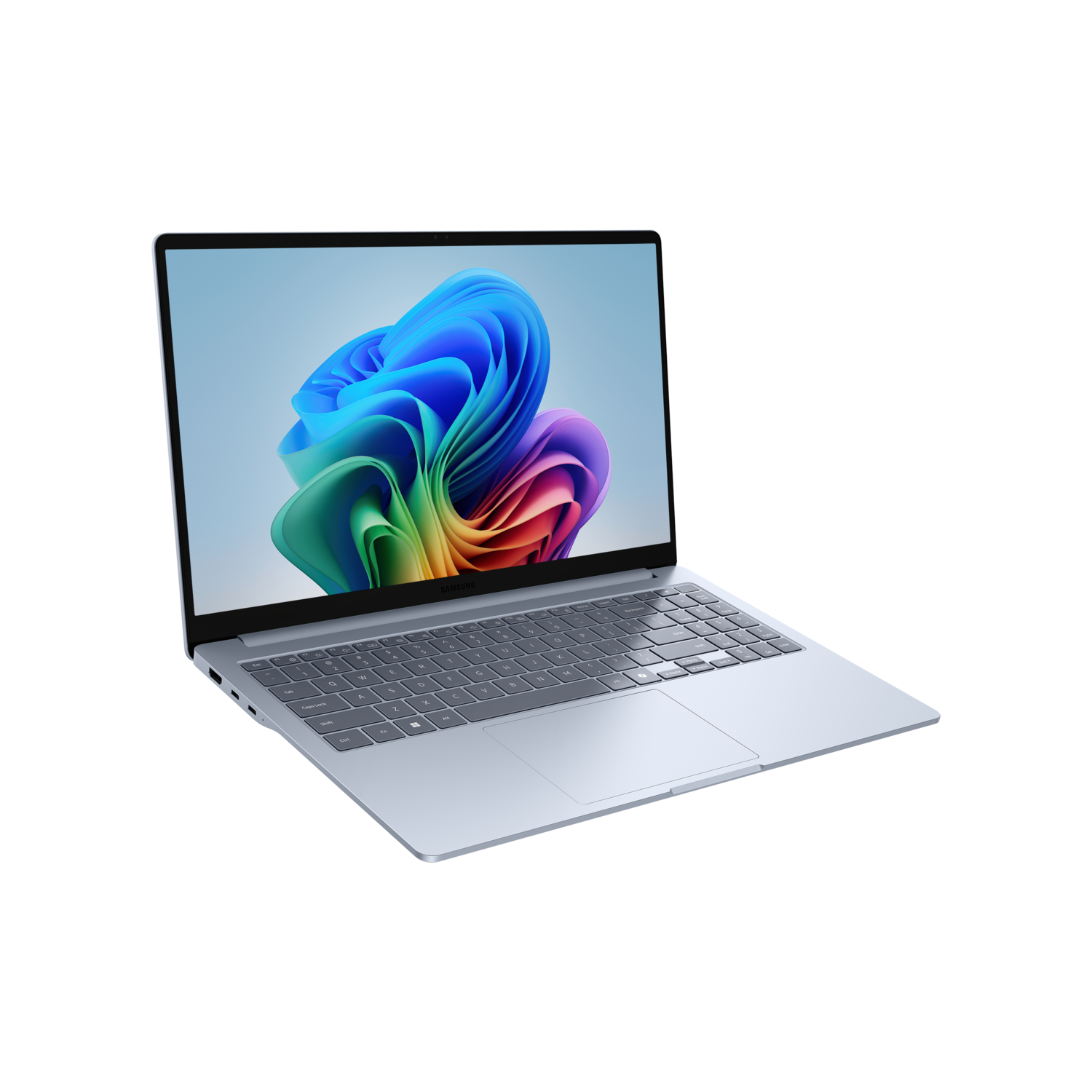 A silver laptop is open on a black surface. The screen displays a colorful abstract design.