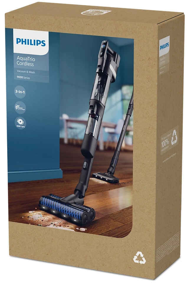 Odkurzacz jest w pudełku. Pudełko stoi na drewnianej podłodze. Pudełko zawiera informacje o produkcie.