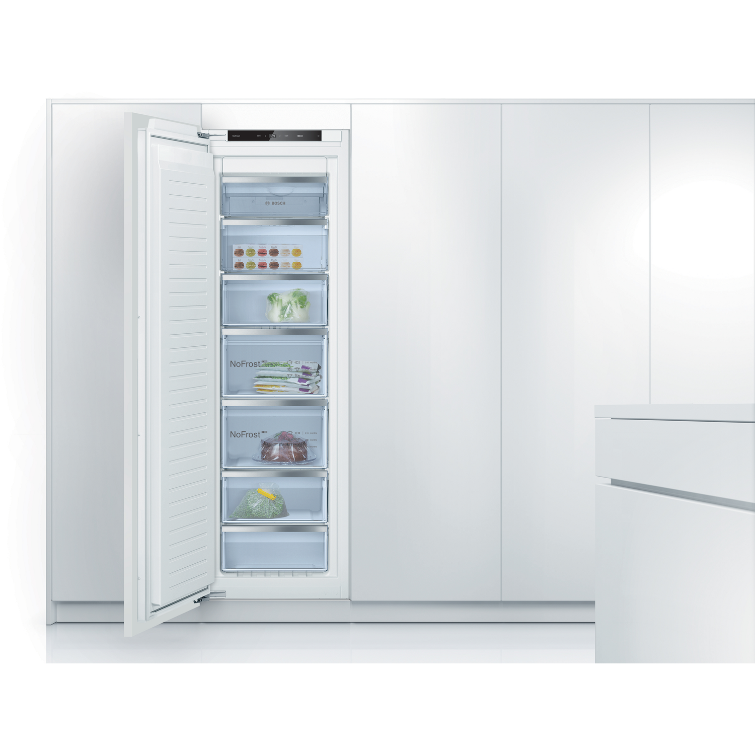 A white freezer with multiple drawers open, showing stored food items.