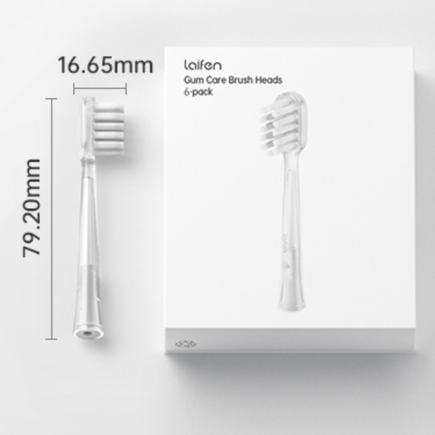 Two toothbrush heads, one in a box, on a white surface.