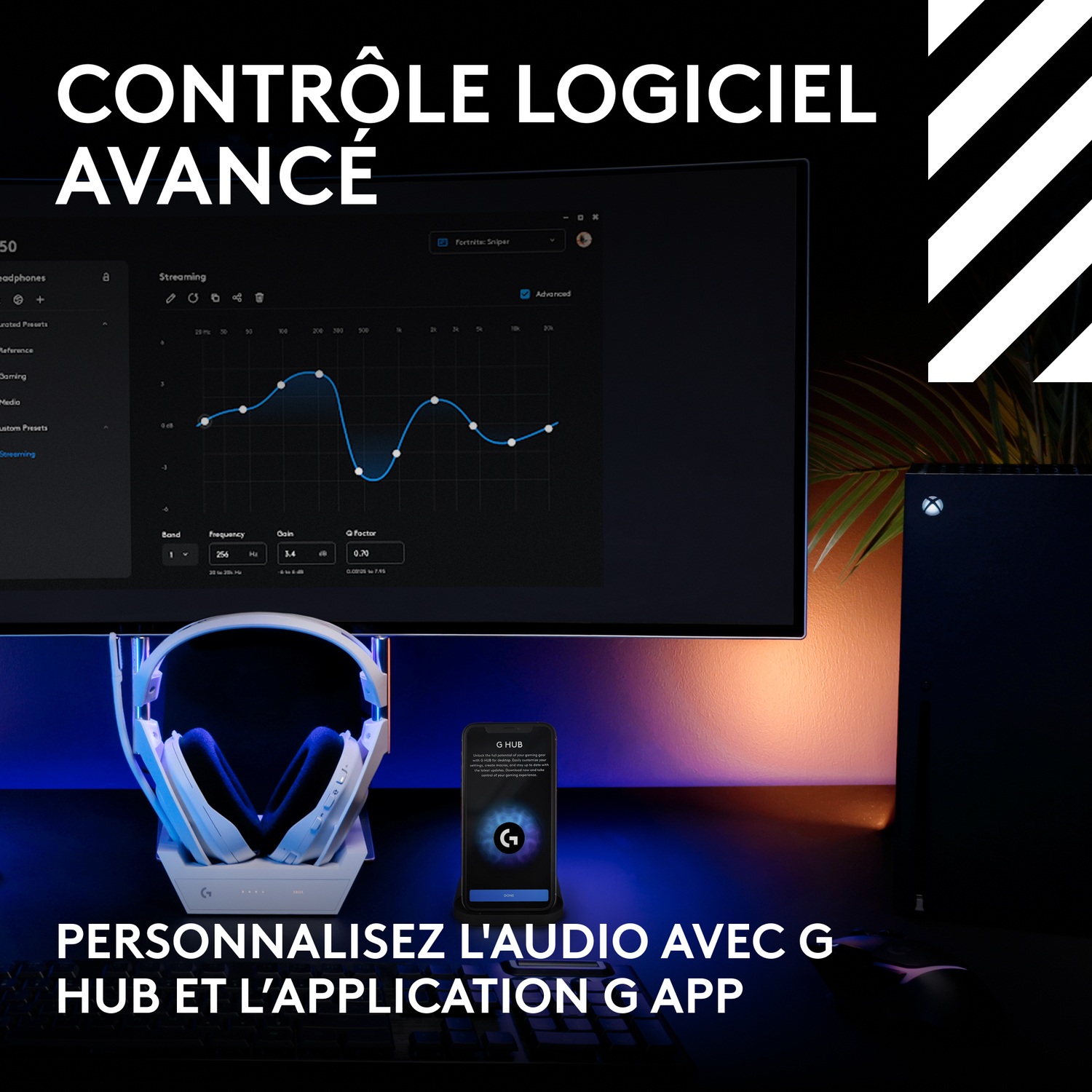 Une configuration de bureau avec un moniteur affichant un graphique, un casque et une console de jeu.