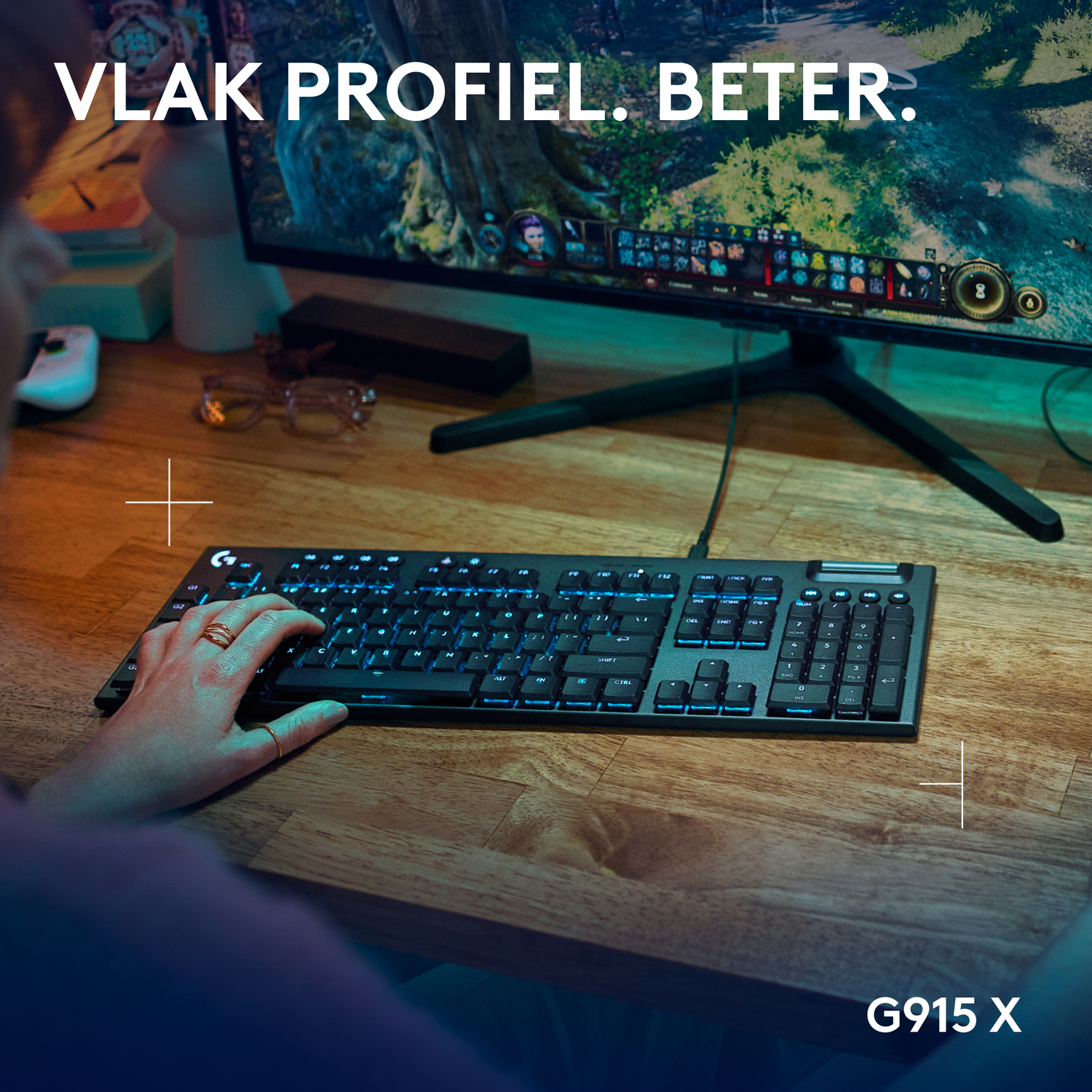 A person's hand using a keyboard with a gaming screen in the background.