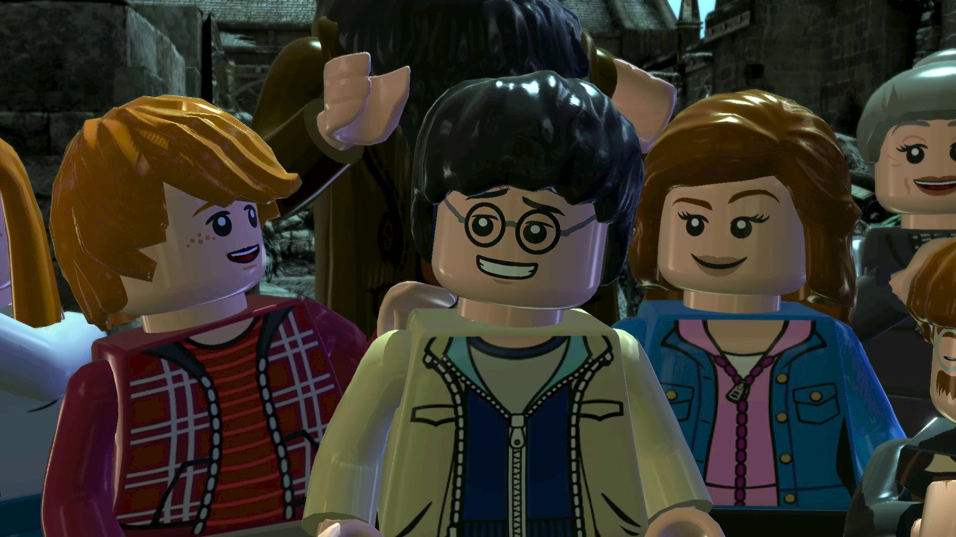 Lego-Charaktere in einer Lego-Welt. Eine rothaarige Frau hält einen Bogen. Zwei Männer sind ebenfalls anwesend.