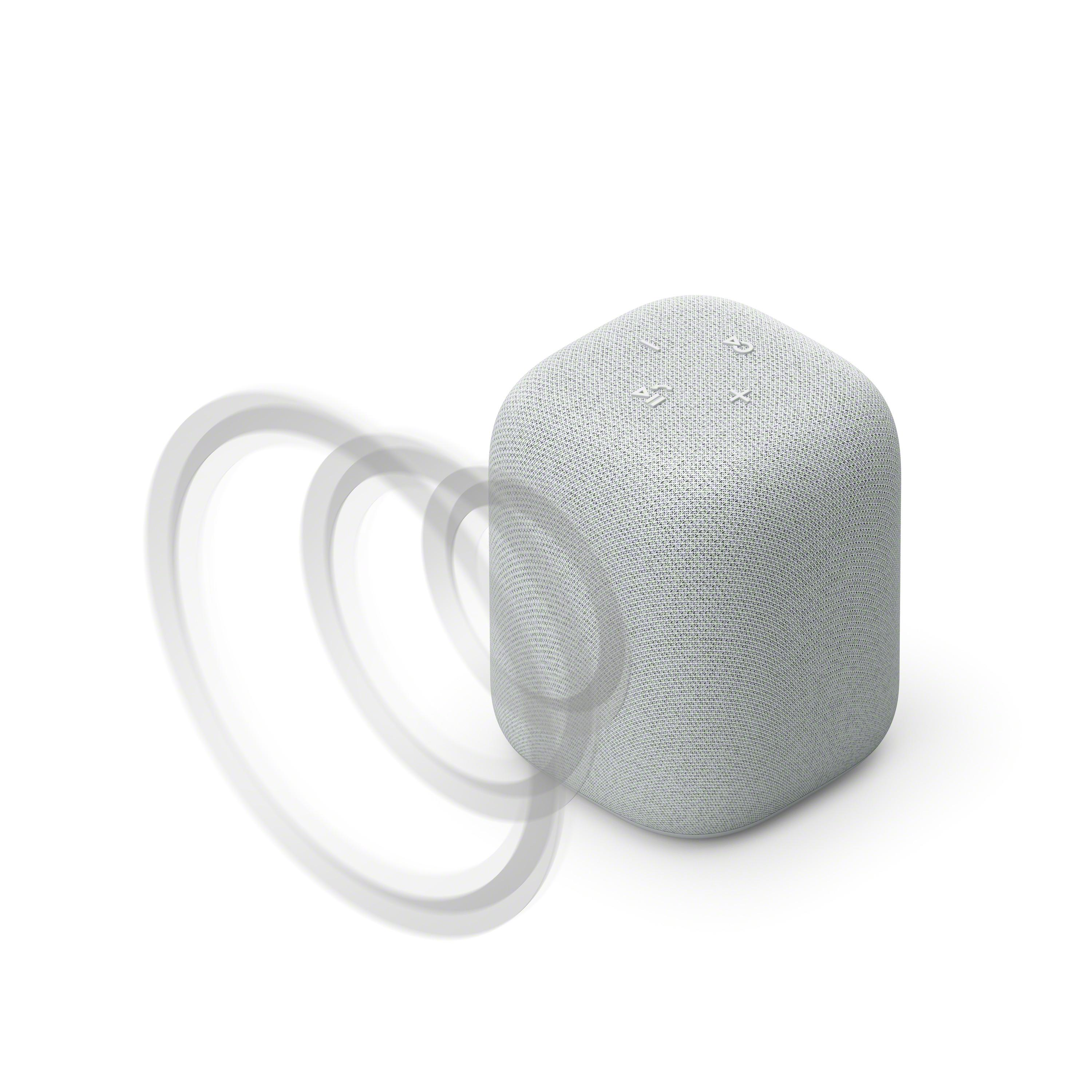 Un altavoz blanco y gris con tres botones en la parte superior y ondas de sonido que emanan del lateral.