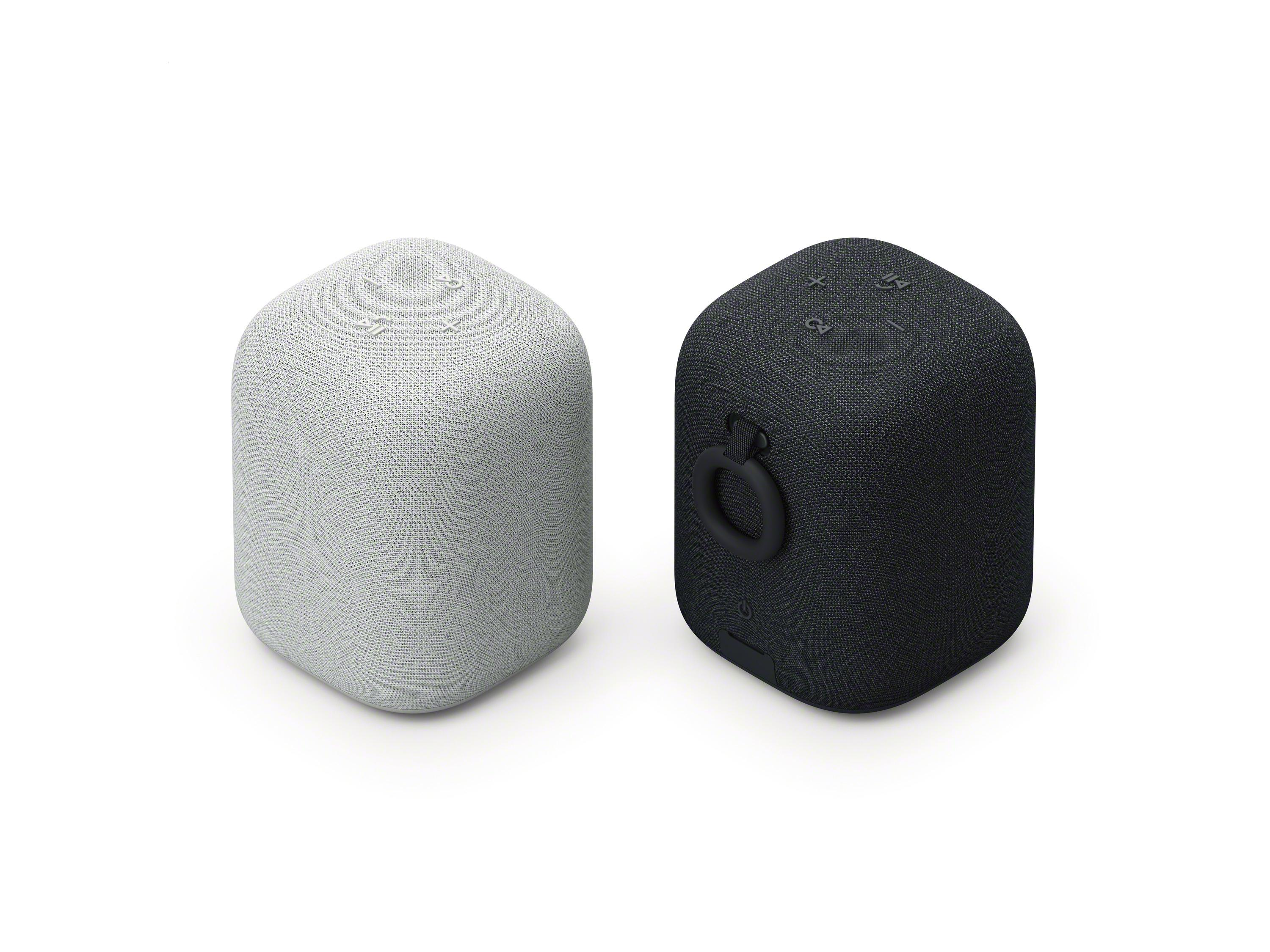 Dos altavoces blancos y negros con forma cilíndrica.