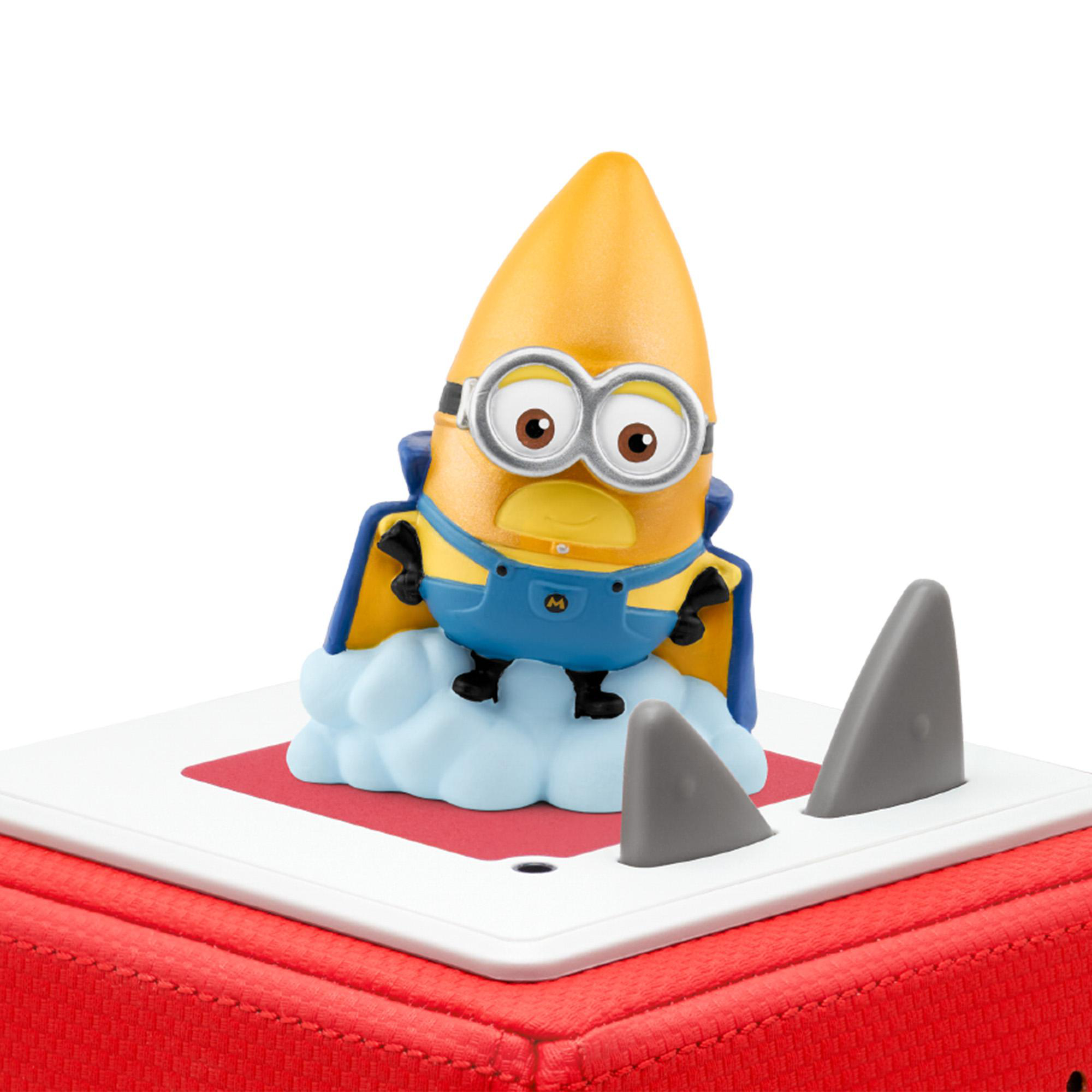 Ein als Superheld verkleideter Minion steht auf einer Wolke auf einer Plattform, mit Haifischflossen drumherum.