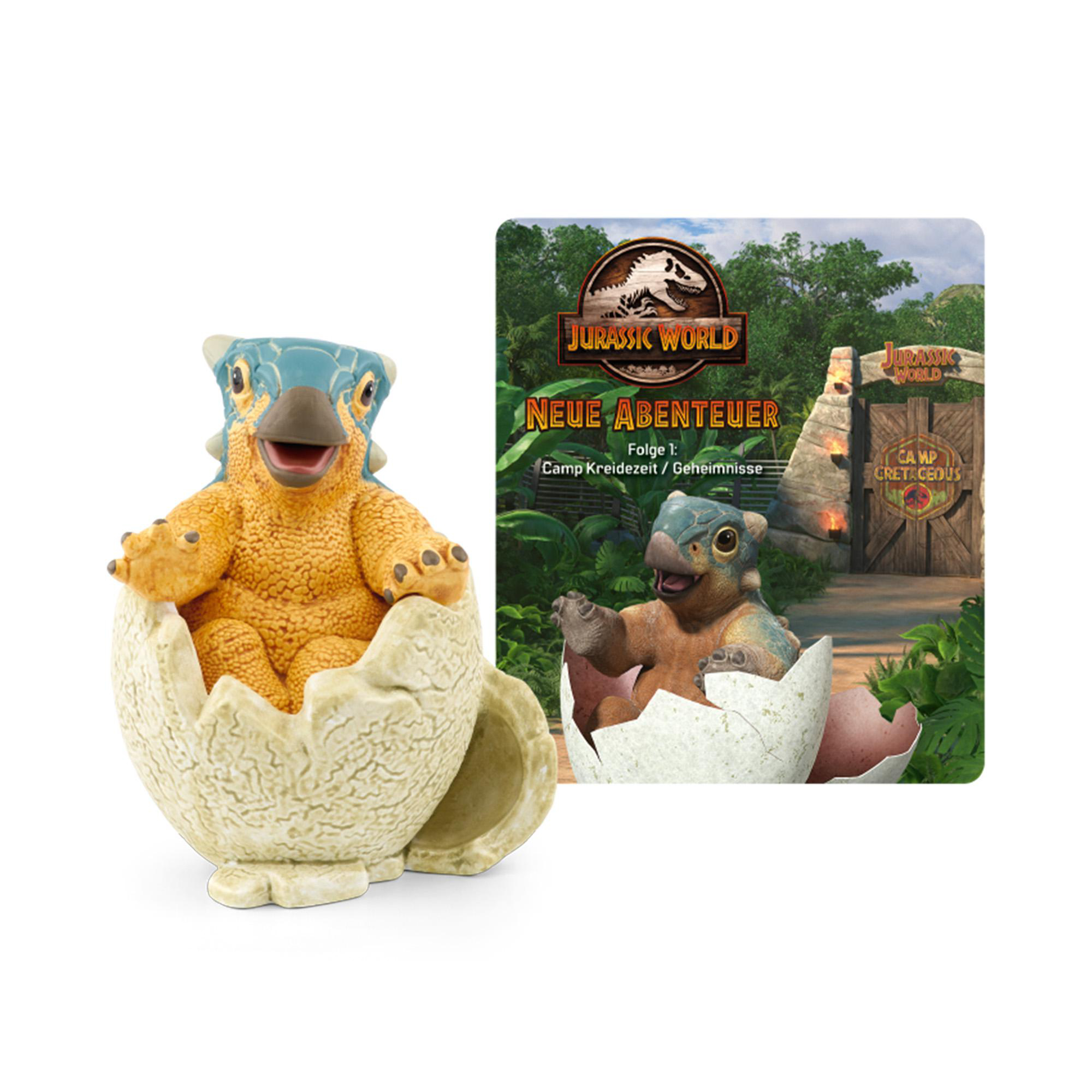 Dinosaurierfigur im Ei, mit Buch mit ähnlichem Bild, weißer Hintergrund.