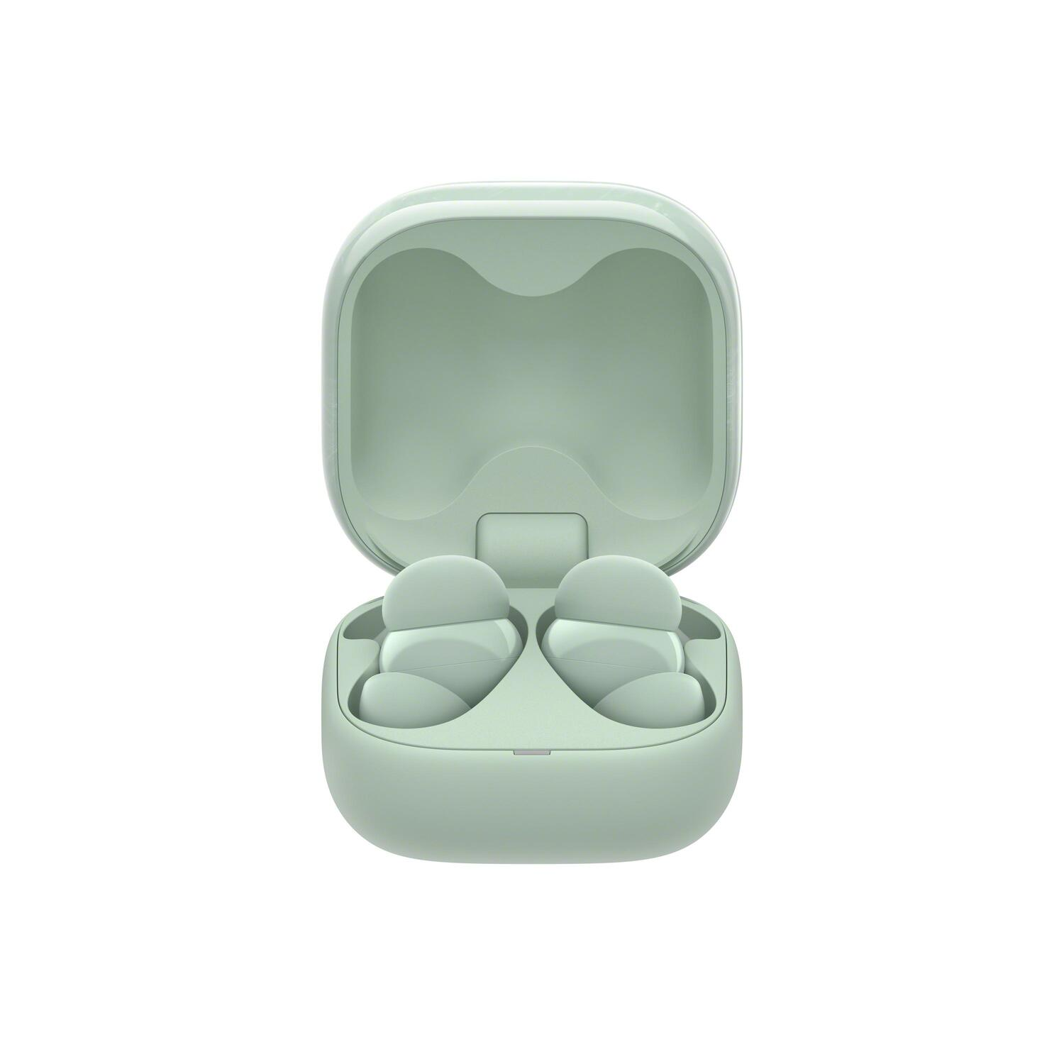 Écouteurs verts clairs ouverts dans un étui de chargement assorti, sur fond blanc.