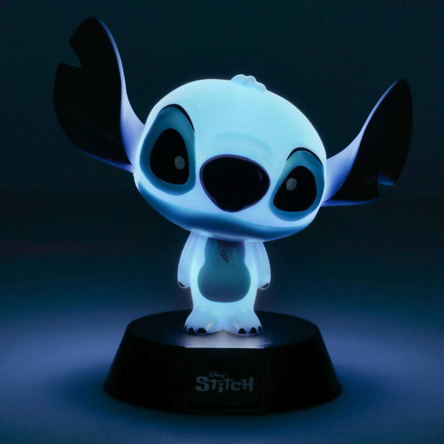 Stitch lamp, blue glow. Stitch figure on a black base, glowing blue against a dark background.