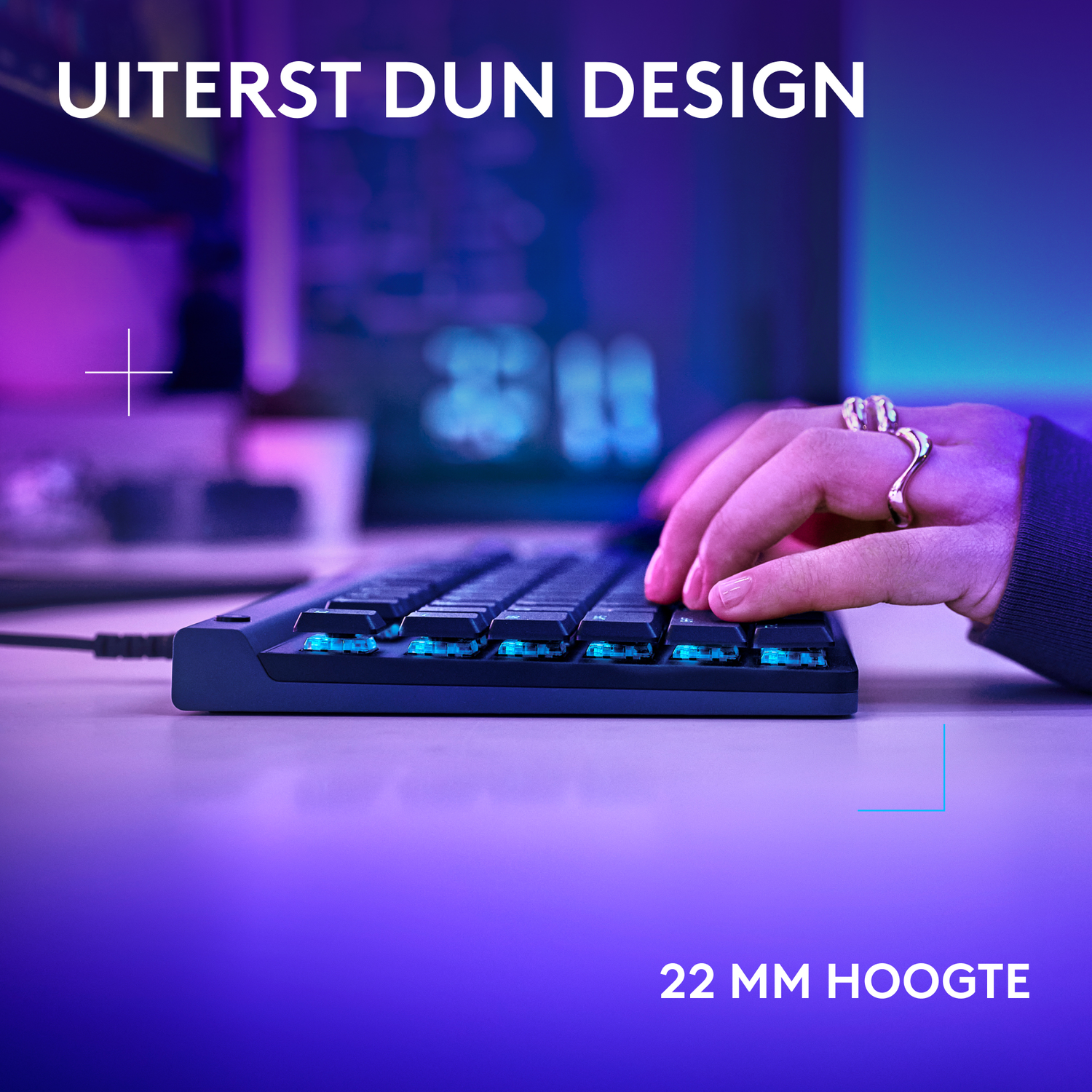 Hands typing on a keyboard with illuminated blue keys. The keyboard is low profile.