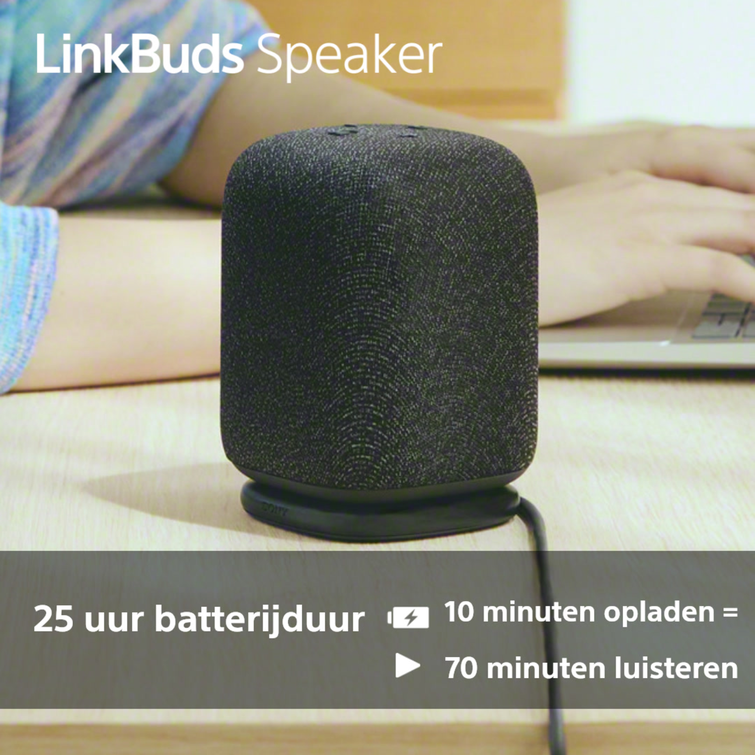 Black speaker on a surface, with text about its battery life and charging speed.