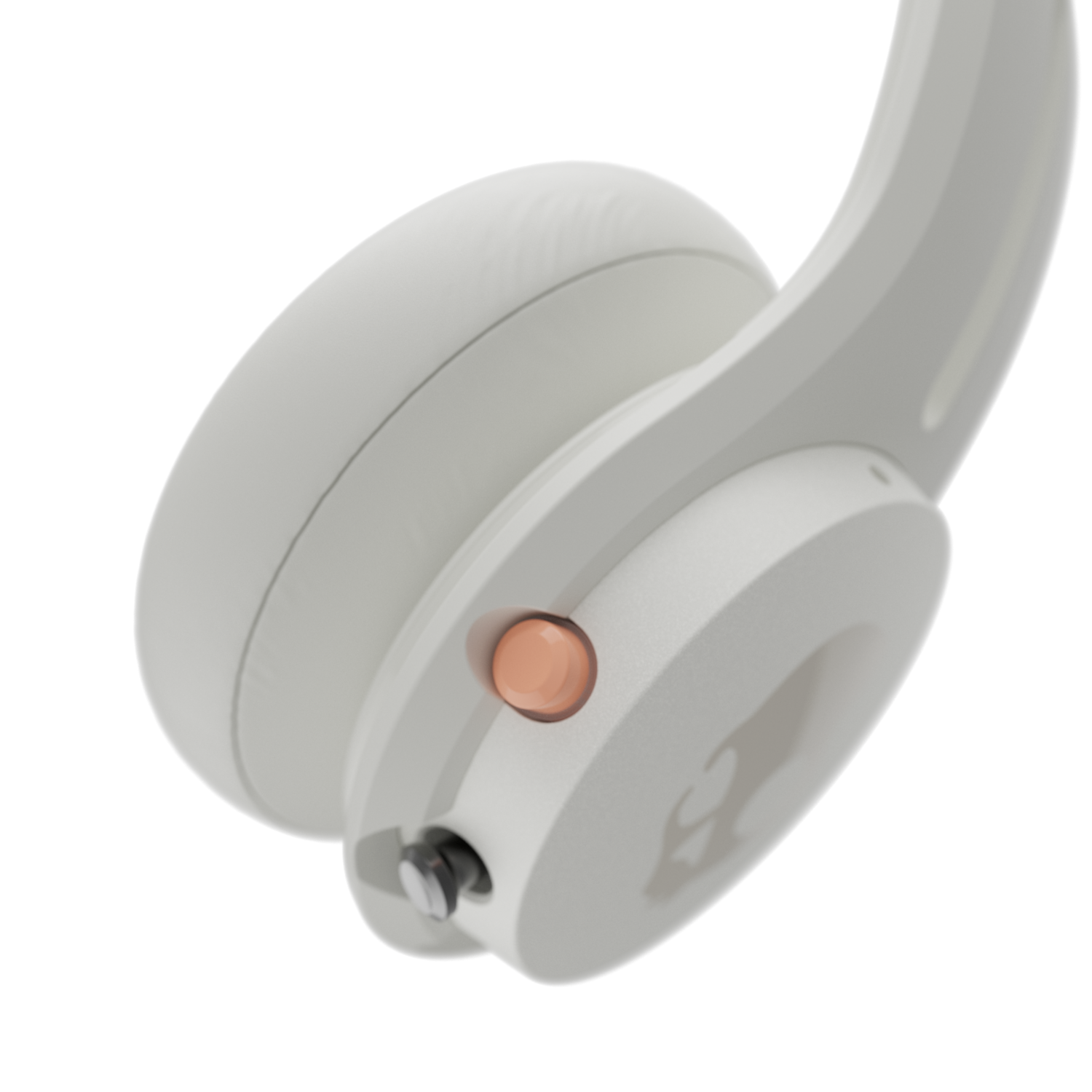 Close-up of a white headset. A copper-colored button is visible. Black background.
