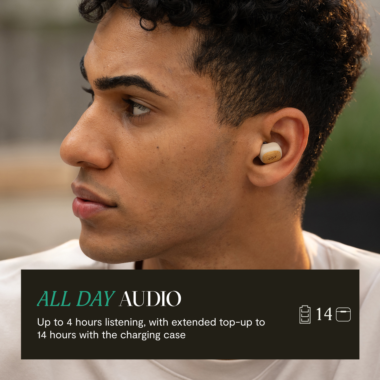 A man wearing earbuds with a wooden finish. Text says 'All Day Audio' and details battery life.