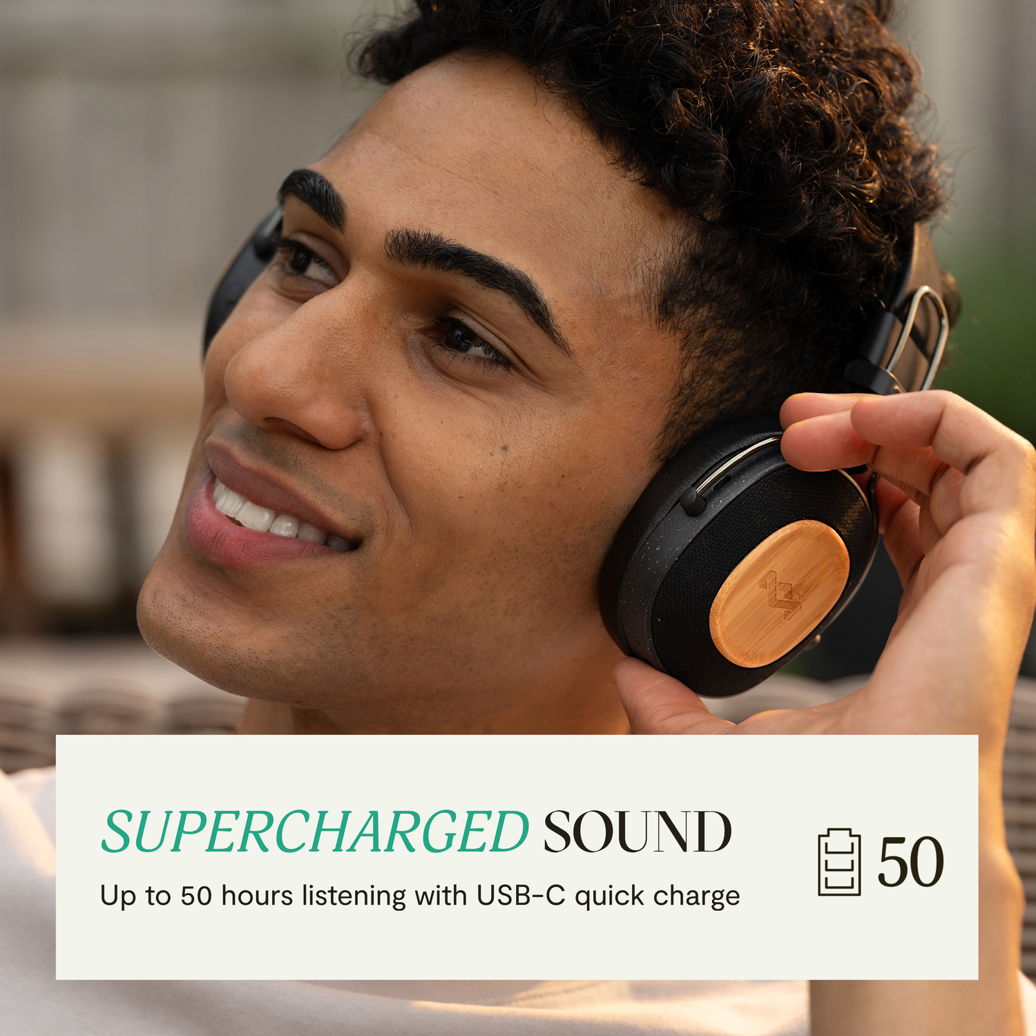 A man wearing headphones. Text reads SUPERCHARGED SOUND, and 50 next to a battery icon.