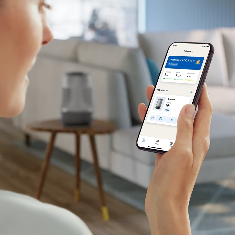 Osoba trzymająca telefon z aplikacją pokazującą jakość powietrza.