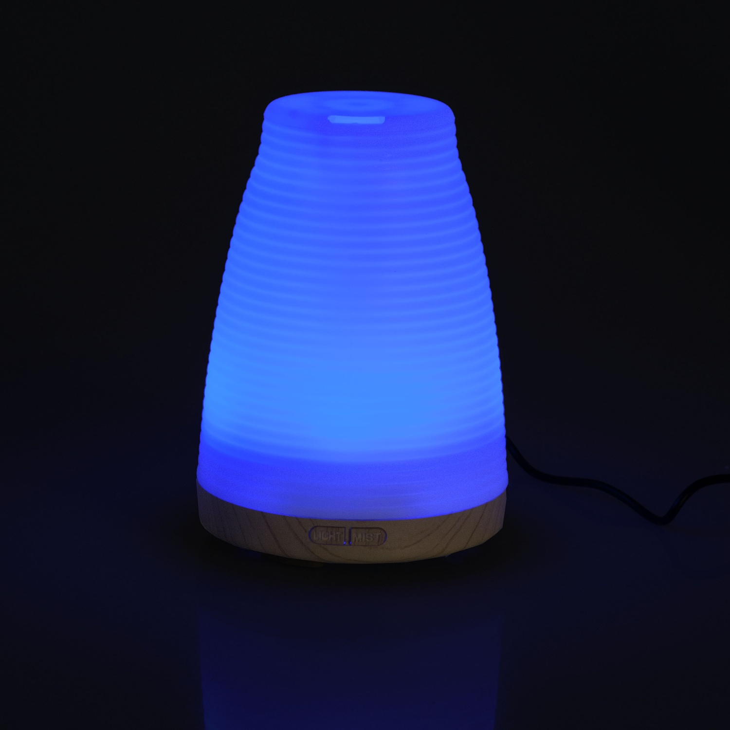 Un diffusore che emette luce blu. La base è color legno.