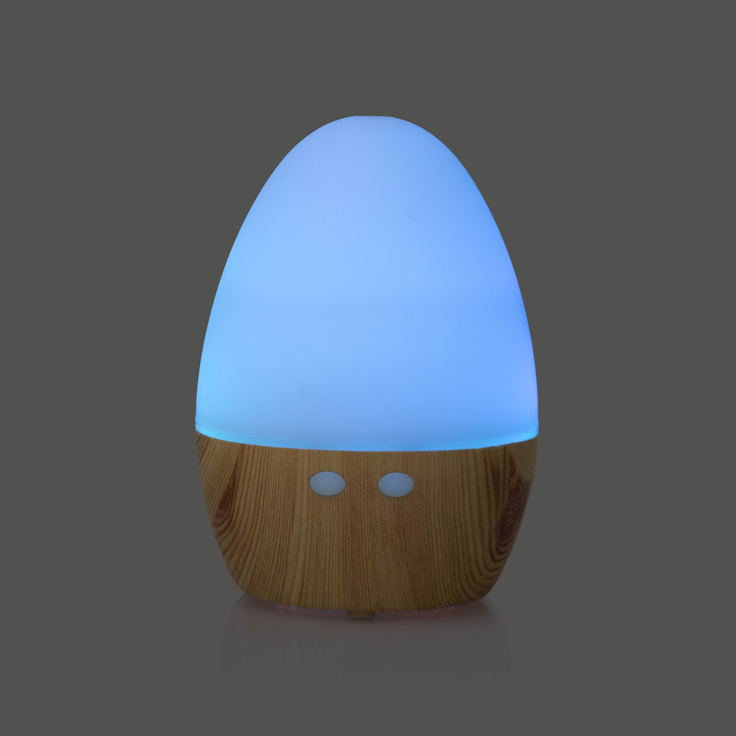Diffusore di aromi a forma di uovo con luce blu e base in legno.