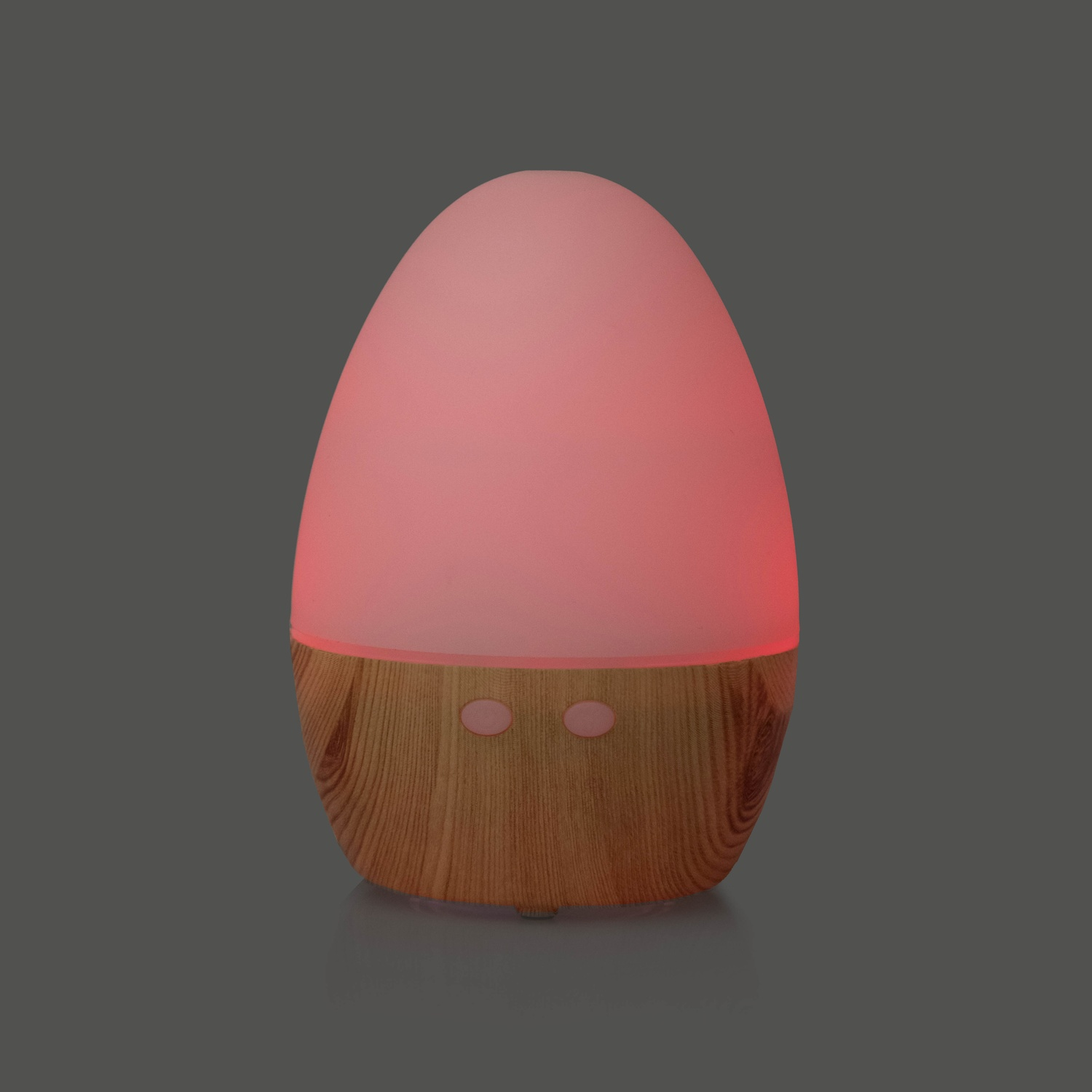 Diffusore a forma di uovo con luce rosa. Base in legno con due pulsanti.