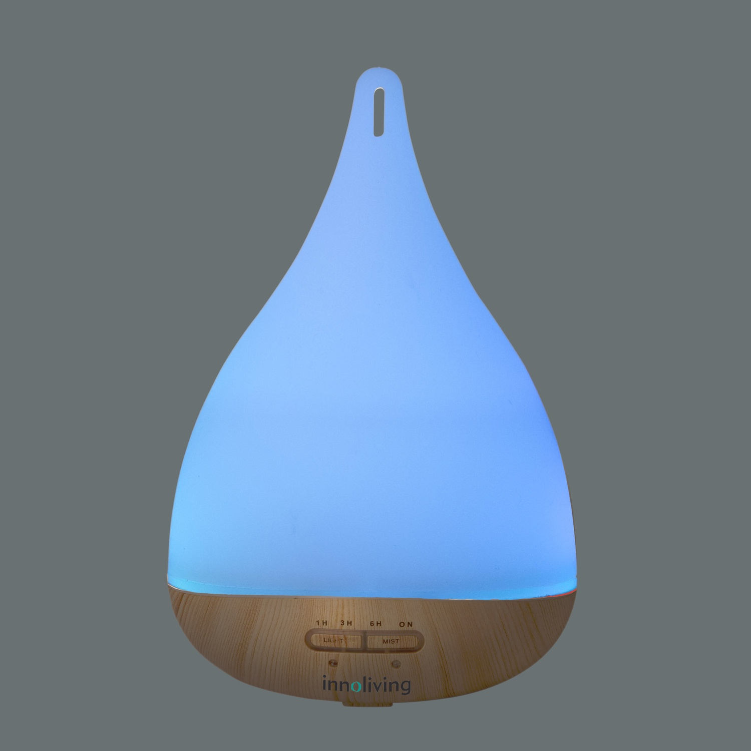 Diffusore di oli essenziali bianco e color legno con bagliore blu, su sfondo grigio.