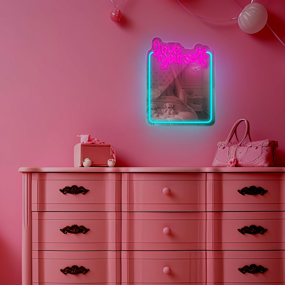 Rózsaszín hálószoba dekoráció: komód, neon felirat, 'Love Yourself' és egy kézitáska.