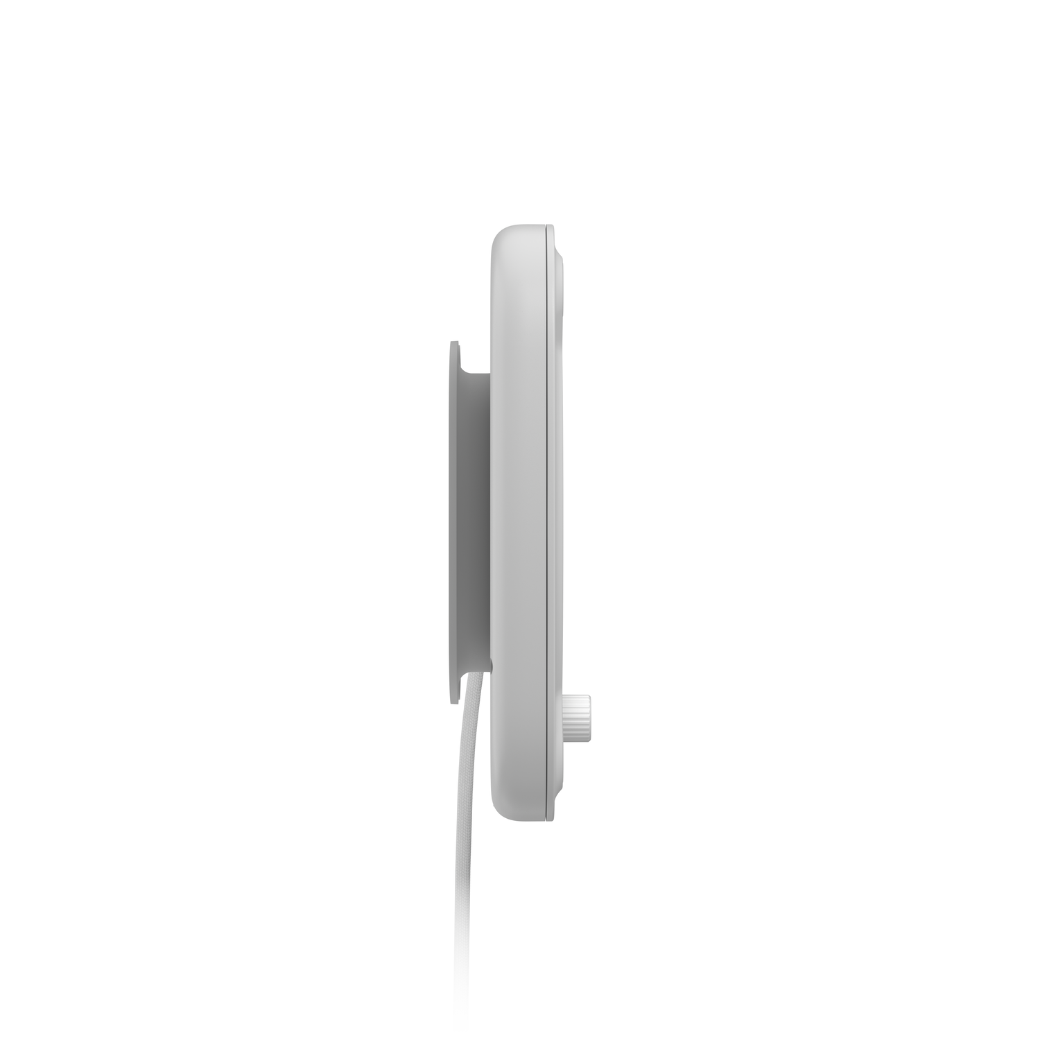 A side view of a white device with a cable attached. It is mounted on a wall.